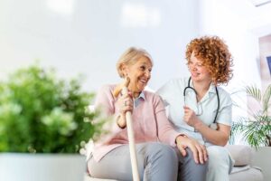 Nurse reviewing a medication chart with an older resident in a bright assisted living room.