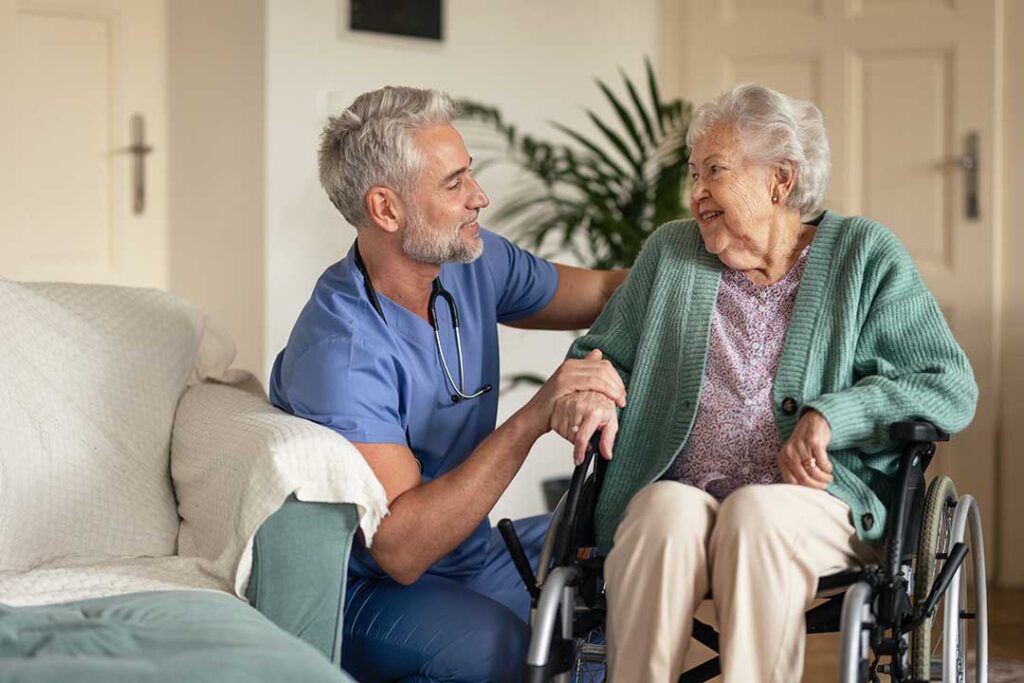 Family member reviews a care plan with an older adult at a table in an assisted living room.